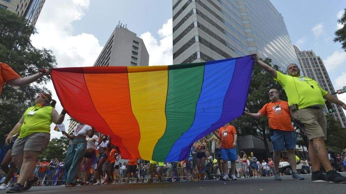File photo: Participants carry the rainbow flag in uptown Charlotte at the close of a Charlotte Pride Parade.