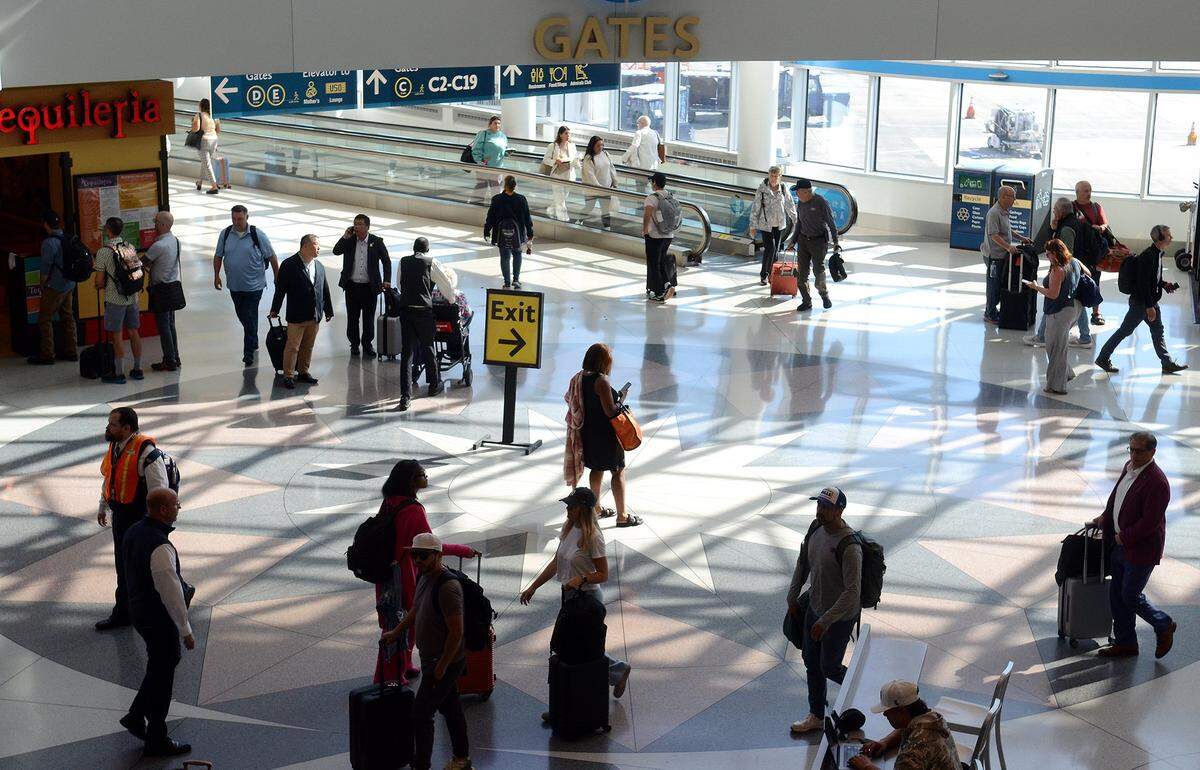 Passengers flow through Charlotte Douglas International Airport.  Passengers are dealing with flight delays because of the government shutdown. 