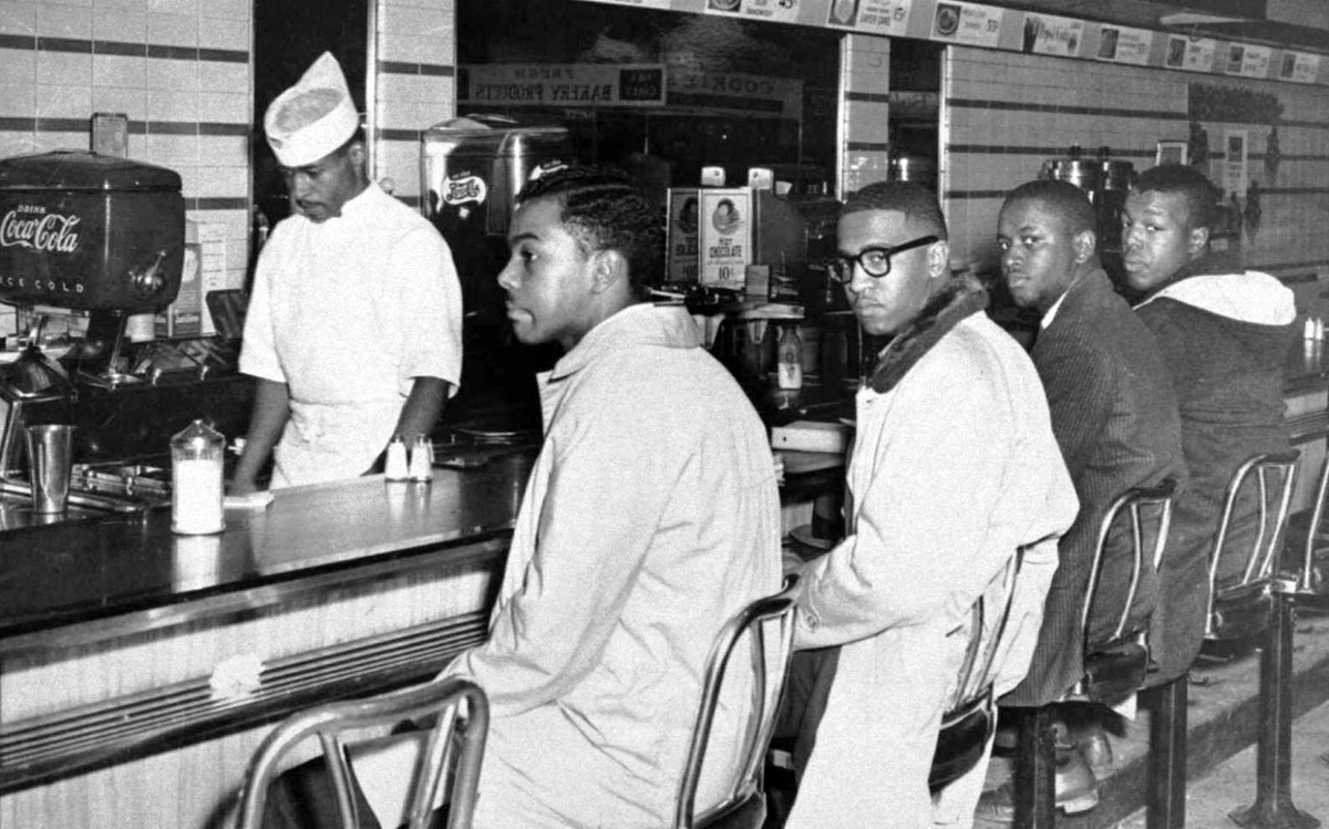 A group of 20 A&T College students occupied lunch counter seats at the downtown F.W. Woolworth Co. store on the second day of the protest. Four shown from left are Joseph McNeil, Franklin McCain, Billy Smith and Clarence Henderson.