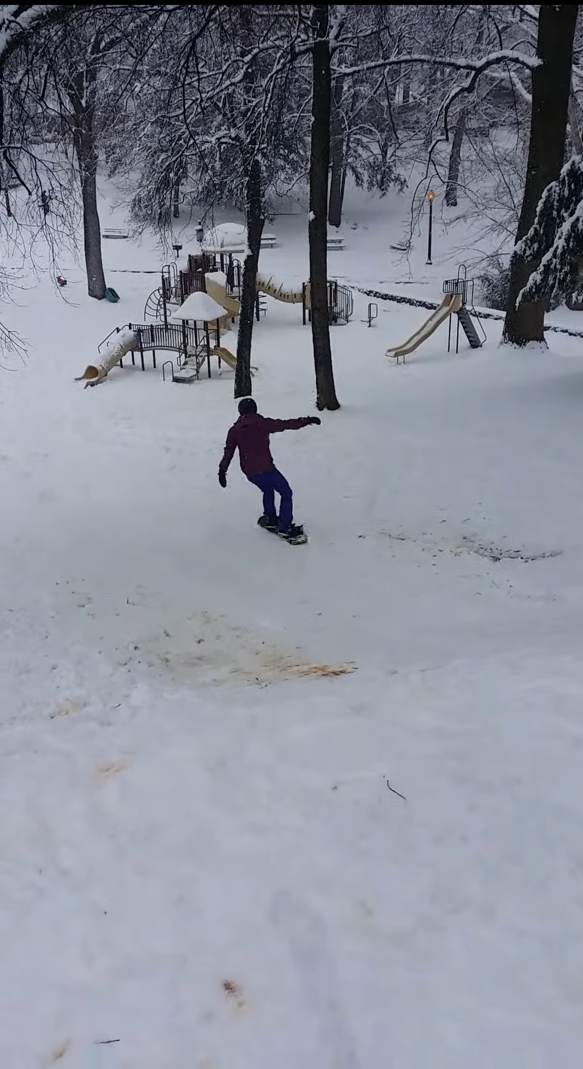 Megan Phillips is photographed in 2014 near Camden and Tremont in South End. “We were supposed to go snowboarding in Colorado but the Charlotte snow canceled our flights,” Sam Phillips said. “We decided to take our snowboards out and ended up on the Charlotte mountains of Latta Park.”