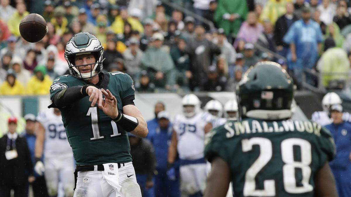 Philadelphia Eagles quarterback Carson Wentz, left, utilizes the short passing game with his team’s bevy of targets, including running back Wendell Smallwood (28).