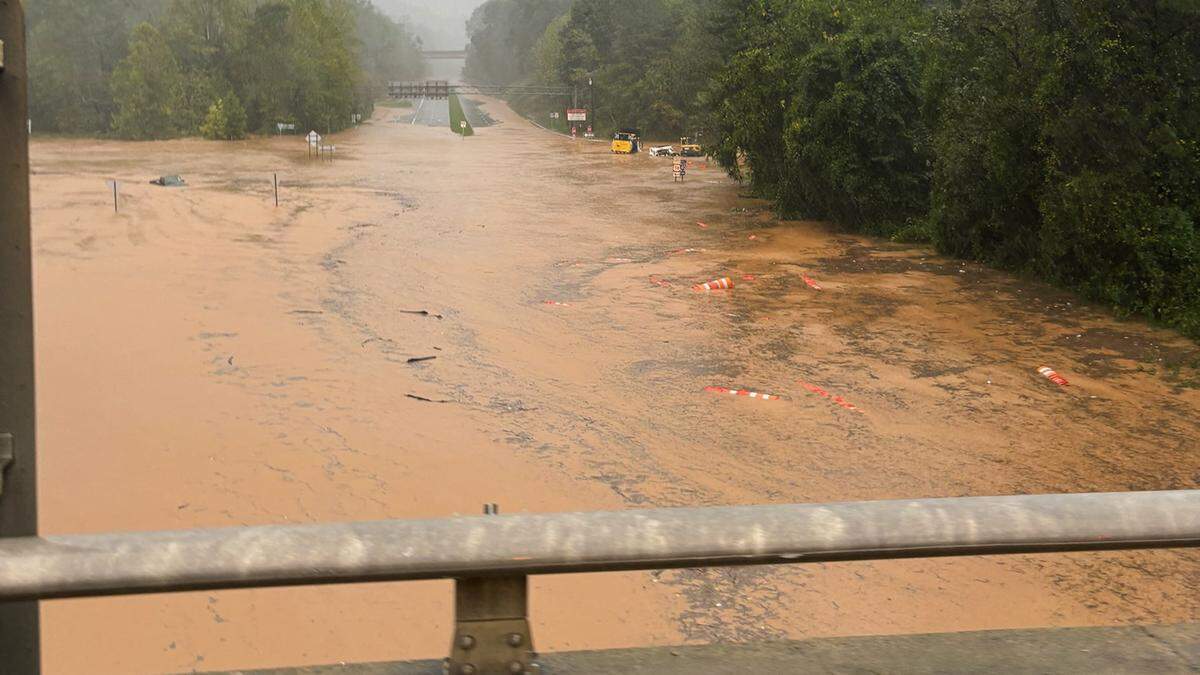 Flood waters rage on US 74 looking down from the I-40 bridge near Asheville, N.C. as Helene dumped heavy rain on the area Friday.