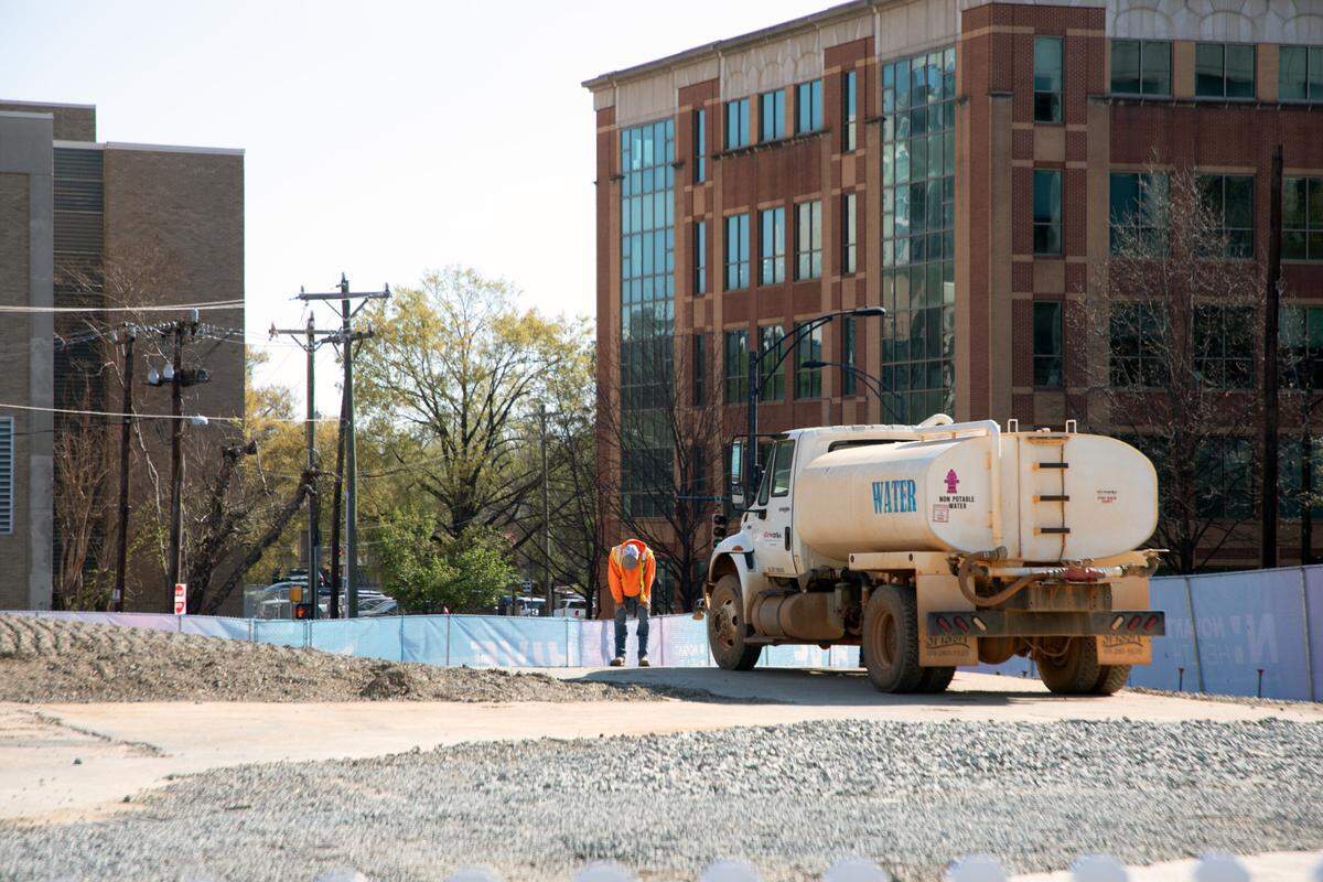A construction worker rubs his knees during the groundbreaking of the Charlotte Hornets’ new performance center uptown on Wednesday, March 26, 2025. 