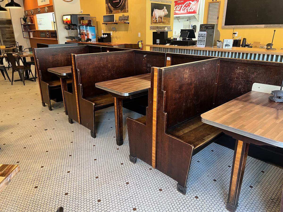 Generations of folks in Elkin had etched their names or initials into the booths at Royall’s Soda Shop in Elkin. Now, they remain a piece of the town’s history, as The Crazy Pig is keeping them in the dining room.