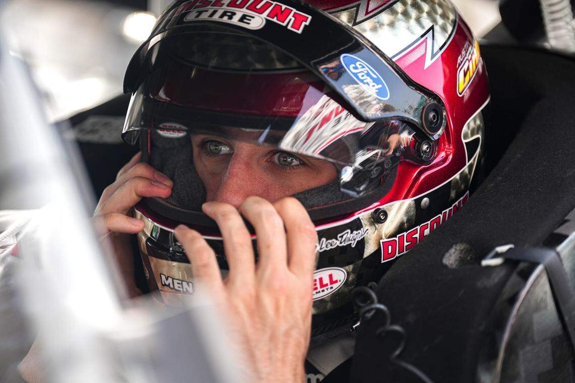 Discount tire Ford driver Austin Cindric adjusts his helmet in his car ahead of the NASCAR EchoPark Automotive Grand Prix at the Circuit of the Americas on Sunday, Mar. 26, 2023 in Austin.