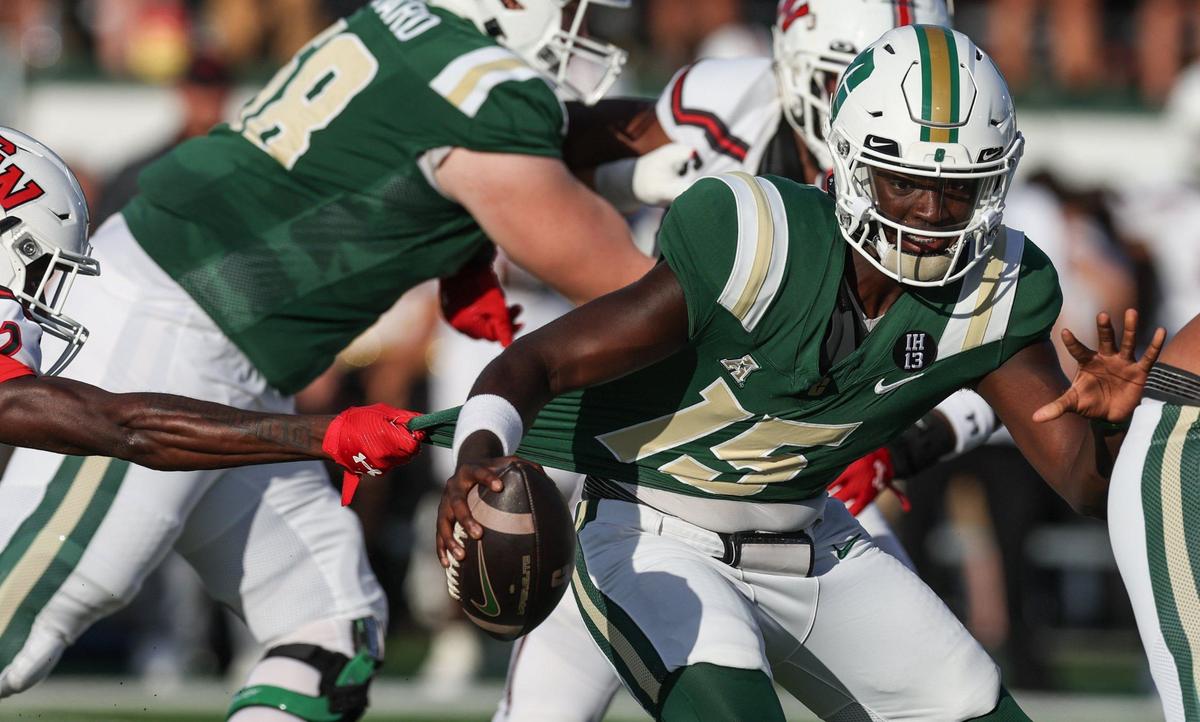 Charlotte quarterback Deshawn Purdie’s jerey is yanked as he runs with the ball during the game against Gardner-Webb at Jerry Richardson Stadium in Charlotte, NC on Saturday, September 14, 2024.