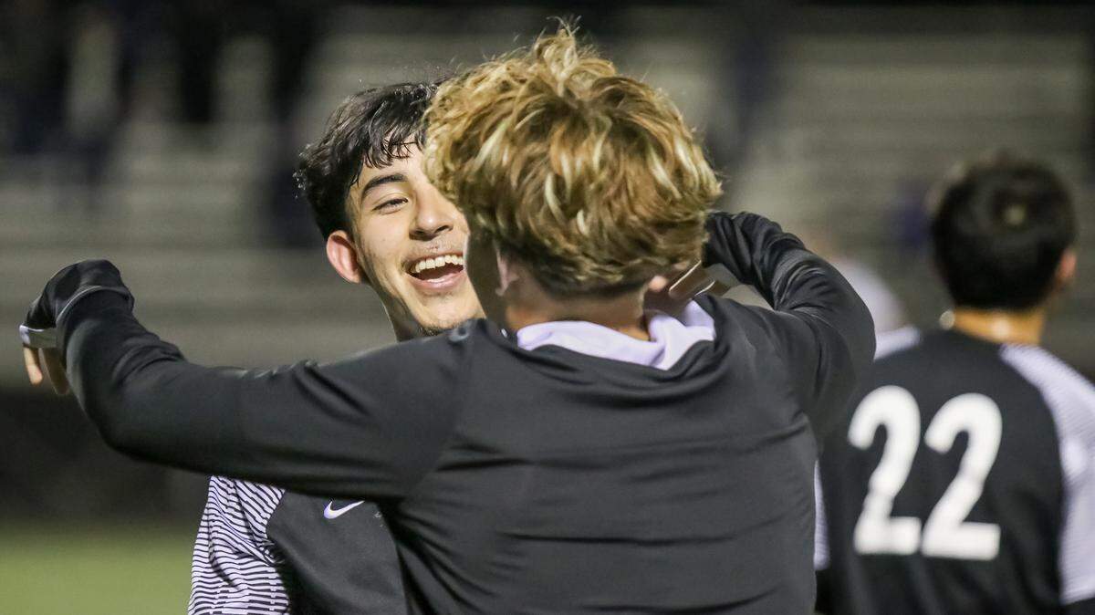 Garinger players run to the field and hug their teammate’s after securing a spot in the third round of playoffs after the second round playoff game at Garinger high school on Tuesday November 12th at 7:00pm