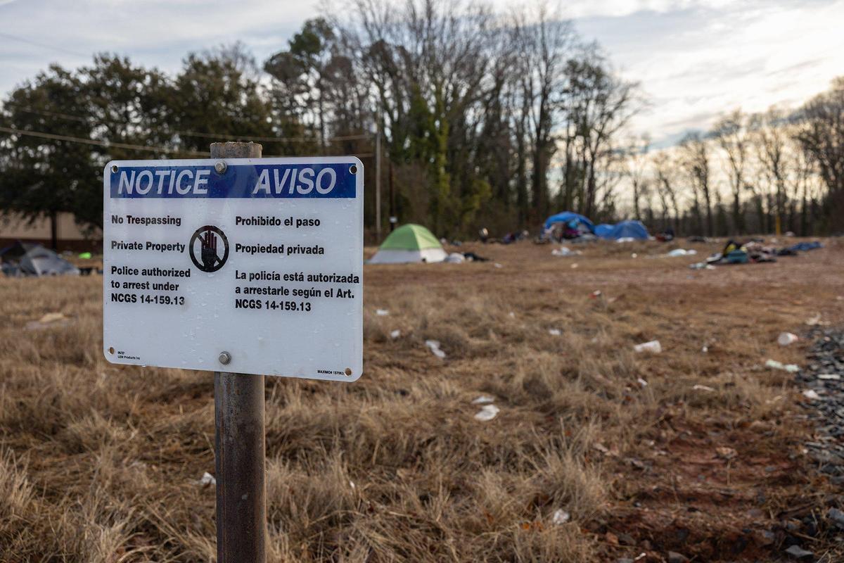 A lot is occupied by people living in tents on Sugar Creek road in Charlotte, N.C., on Friday, February 10, 2023.