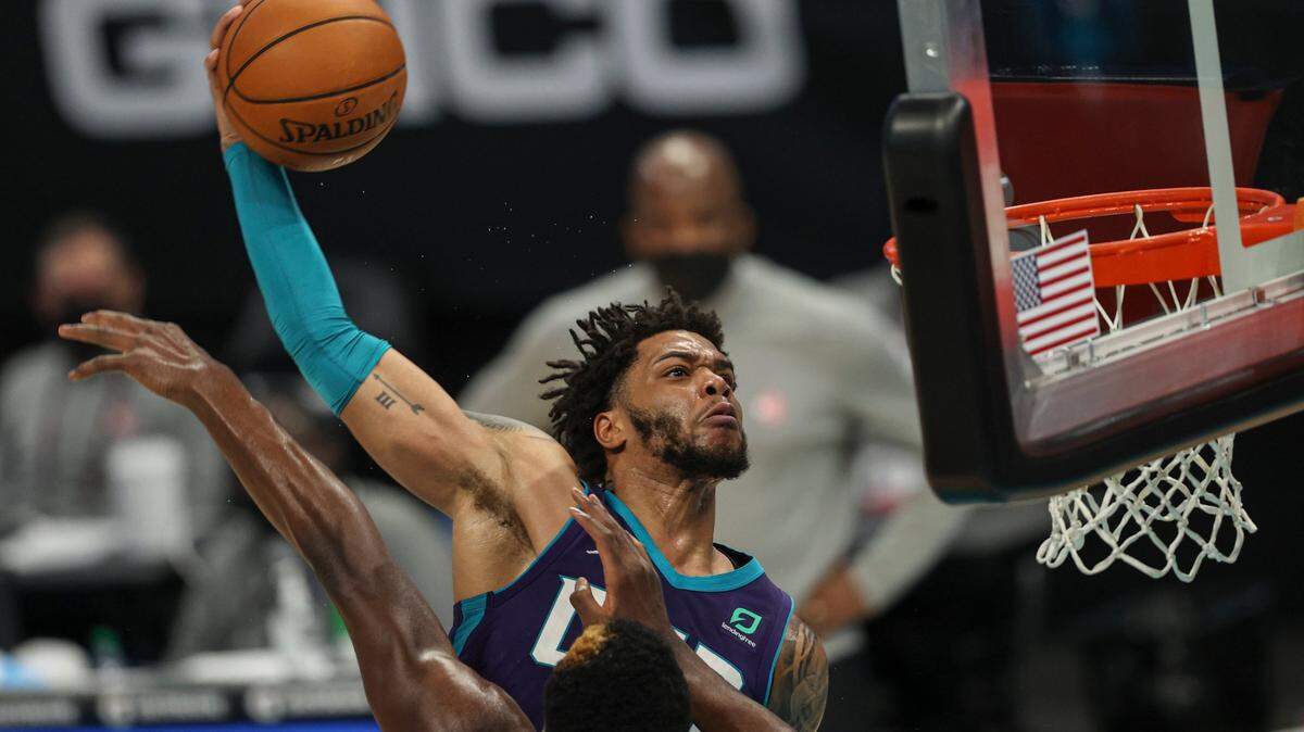 Charlotte Hornets forward Miles Bridges, right, prepares to dunk over Atlanta Hawks center Clint Capela, left, during the fourth quarter Sunday. Bridges said the dunk was one of his best thre ever, but Charlotte lost, 105-101.
