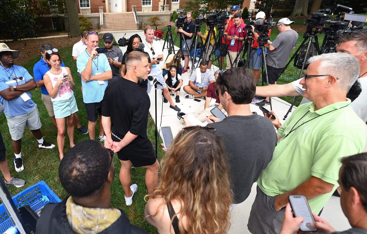 Carolina Panthers running back Christian McCaffrey, center, speaks to the media on the campus of Wofford College in Spartanburg, S.C., on Tuesday, July 26, 2022. McCaffrey and his teammates arrived at Wofford College on Tuesday to begin training camp. The team’s first practice will be Wednesday, July 27, 2022.