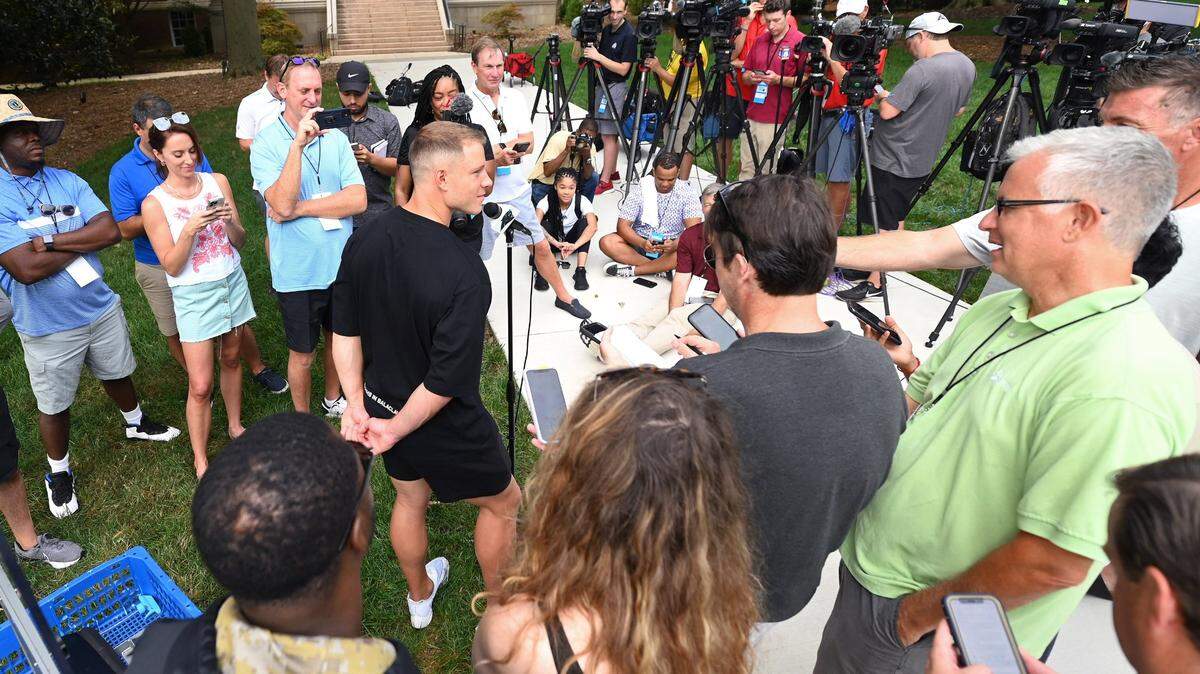 Carolina Panthers running back Christian McCaffrey, center, speaks to the media on the campus of Wofford College in Spartanburg, S.C., on Tuesday, July 26, 2022. McCaffrey and his teammates arrived at Wofford College on Tuesday to begin training camp. The team’s first practice will be Wednesday, July 27, 2022.