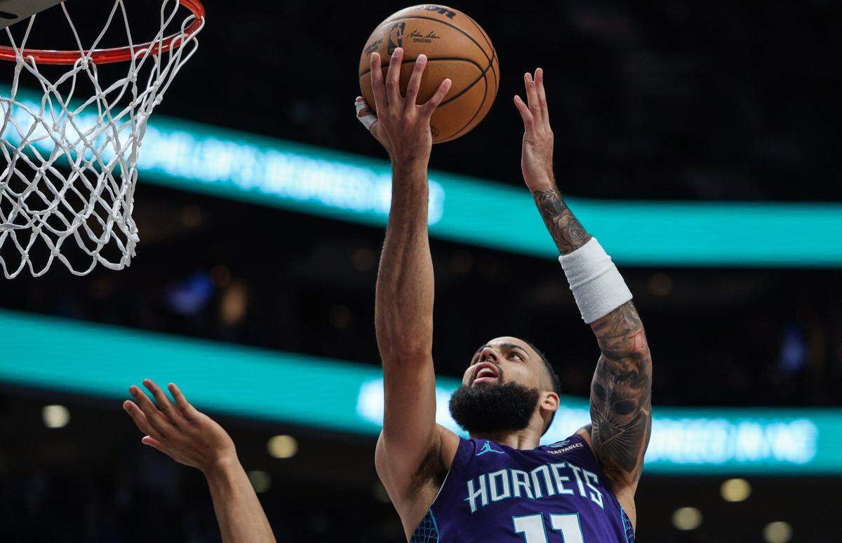 Hornets guard Cody Martin takes the ball tp the hoop during the game against the Spurs at Spectrum Center on Friday, January 19, 2024.