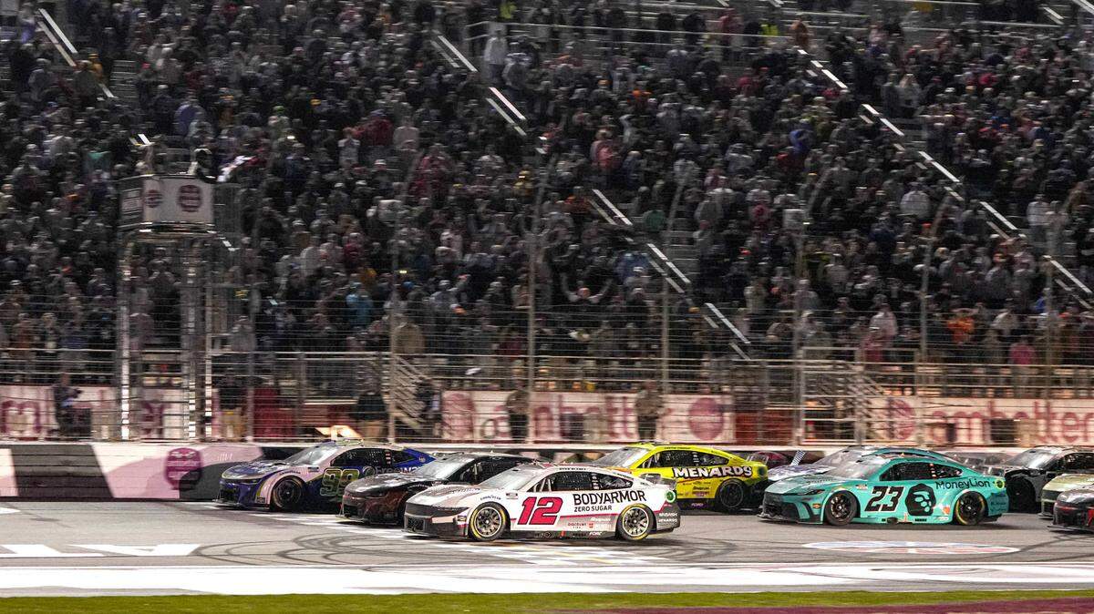 Daniel Suarez (99) (near wall) beats Ryan Blaney (12) to the finish line to win the Ambetter Health 400 at Atlanta Motor Speedway.