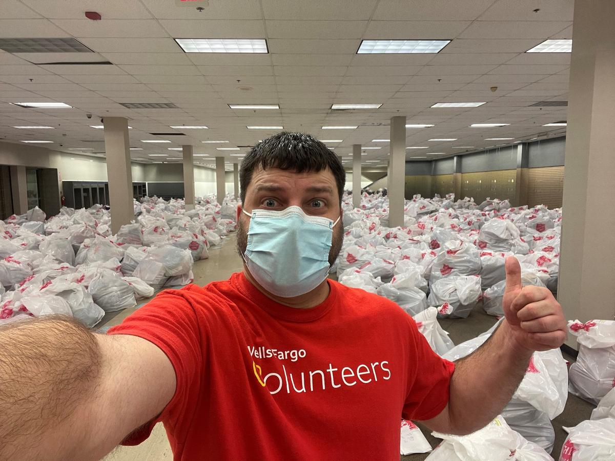 Matthew Leonard has volunteered with the Salvation Army’s Angel Tree program for 14 years through his employer Wells Fargo. Bags of donated gifts are in the background in this 2021 photo.