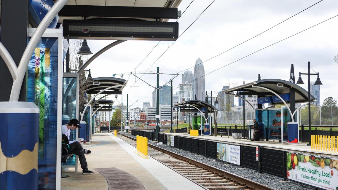 A young man waits at the Parkwood Station for the blue line LYNX light rail, heading toward UNC Charlotte, on Monday, March 13, 2023.