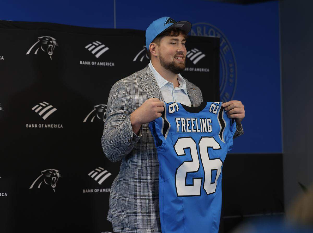 Carolina Panthers draft pick Monroe Freeling, holds his new jersey during a press conference at Bank of America Stadium on Friday, April 24.