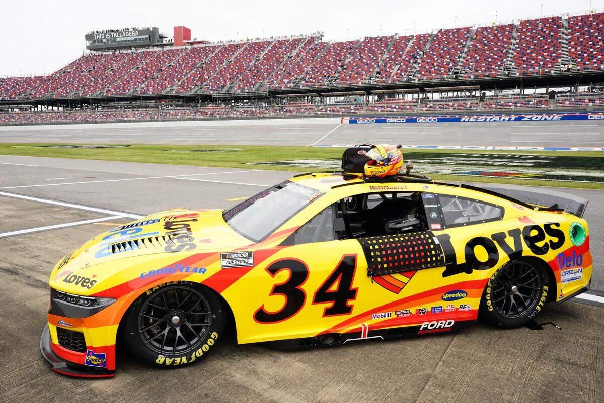 Apr 20, 2024; Talladega, Alabama, USA; NASCAR Cup Series driver Michael McDowell (34) Ford Mustang along pit road after setting the pole during qualifying for the Geico 500 at Talladega Superspeedway.