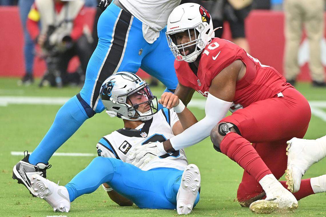 Arizona Cardinals linebacker Josh Sweat (10) tackles Carolina Panthers quarterback Bryce Young (9) during the first quarter Sunday. Young turned the ball over on each of Carolina’s first two possessions.