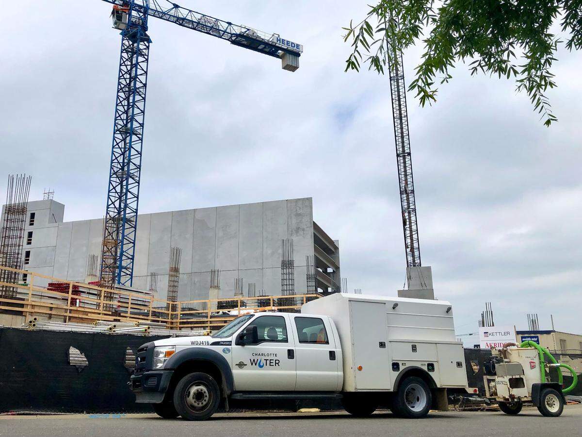A Charlotte Water truck is parked along a construction site on Dunavant Street near Hawkins Street in South End on Thursday, May 5, 2022. Repairs to a damaged water main could take several hours, according to the city utility.