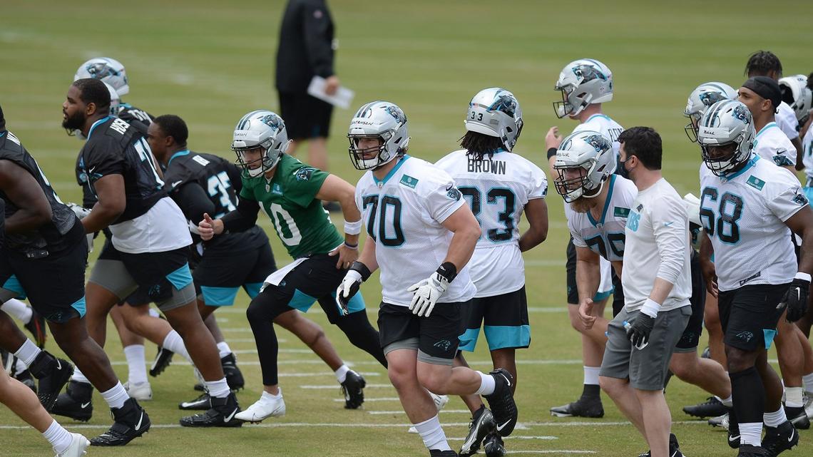 Carolina Panthers rookie tackle Brady Christensen, center, runs across the field with his teammates to begin drills during the teamÕs 2021 rookie minicamp practice on Friday, May 14, 2021.