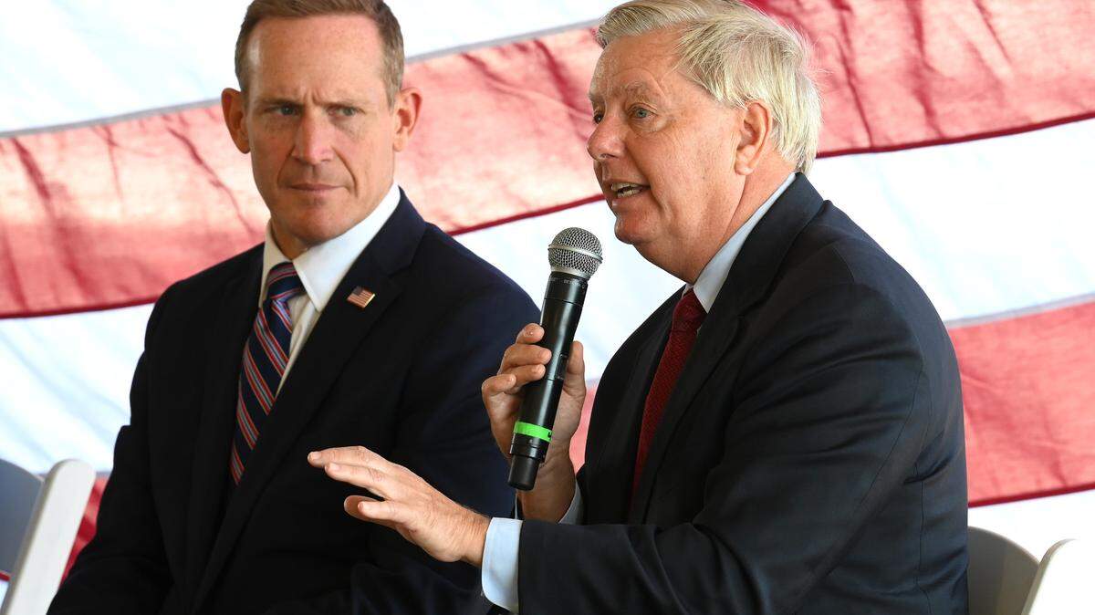 North Carolina candidate for U.S. Senate Ted Budd, left, listens to Senator Lindsey Graham, South Carolina, right, during the Polaris National Security panel discussion at Skyline Terrace in Charlotte, NC on Monday, October 17, 2022