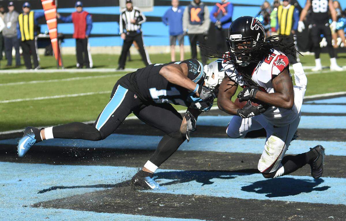 Atlanta Falcons cornerback Desmond Trufant (21) intercepts a pass in the end zone intended for Carolina Panthers wide receiver D.J. Moore (12) in the first half at Bank of America Stadium Sunday. The play was one of Kyle Allen’s three first-half interceptions.