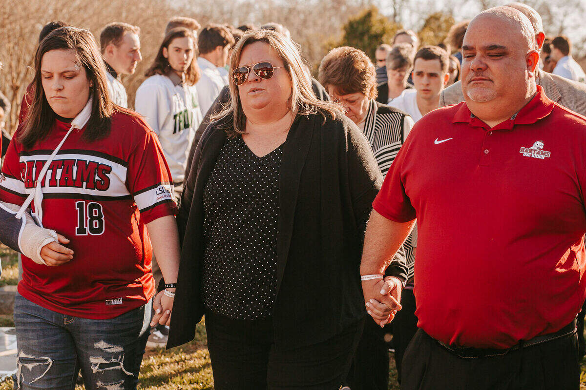 The Stokes family mourns at the funeral of Mia Stokes on Feb. 14 2020. Mia Stokes was killed in a car crash by an allegedly drunk driver in 2020. From left to right is Mallory Stokes (Mia’s twin sister, wearing a cast due to her own injuries in the wreck), mother Holly Stokes and father Eric Stokes.
