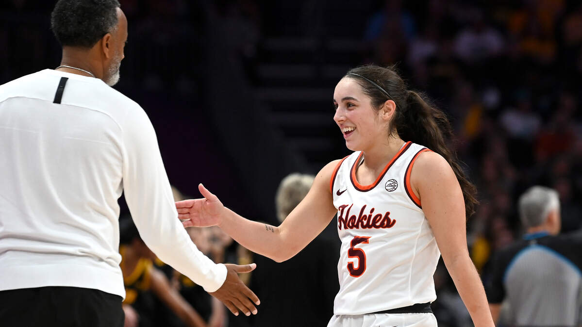 Virginia Tech guard Georgia Amoore, right, is congratulated on her play by head coach Kenny Brooks during a game against Iowa on Nov. 9, 2023 at Spectrum Center in Charlotte. Amoore had 21 points and led Virginia Tech to a win over UNC in Chapel Hill on Sunday, Feb. 4, 2024.