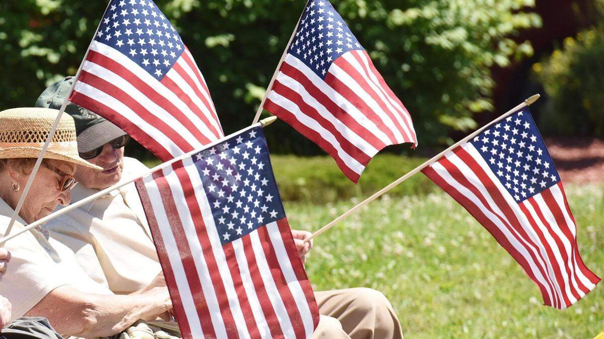 American flags wave during a Fourth of July parade
