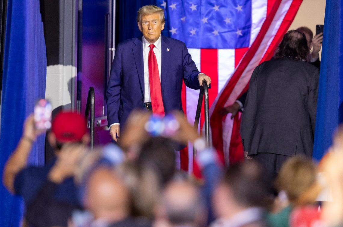 Former President Donald Trump takes the stage during a rally at Minges Coliseum in Greenville on Monday, Oct. 21, 2024.