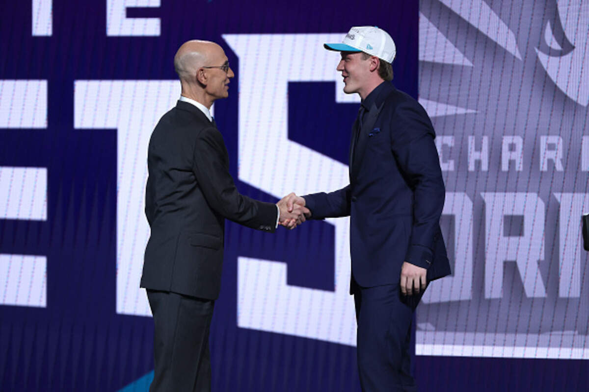 Kon Knueppel, right, shakes hands with NBA commissioner Adam Silver after being drafted fourth overall by the Charlotte Hornets during the first round of the 2025 NBA Draft at Barclays Center.