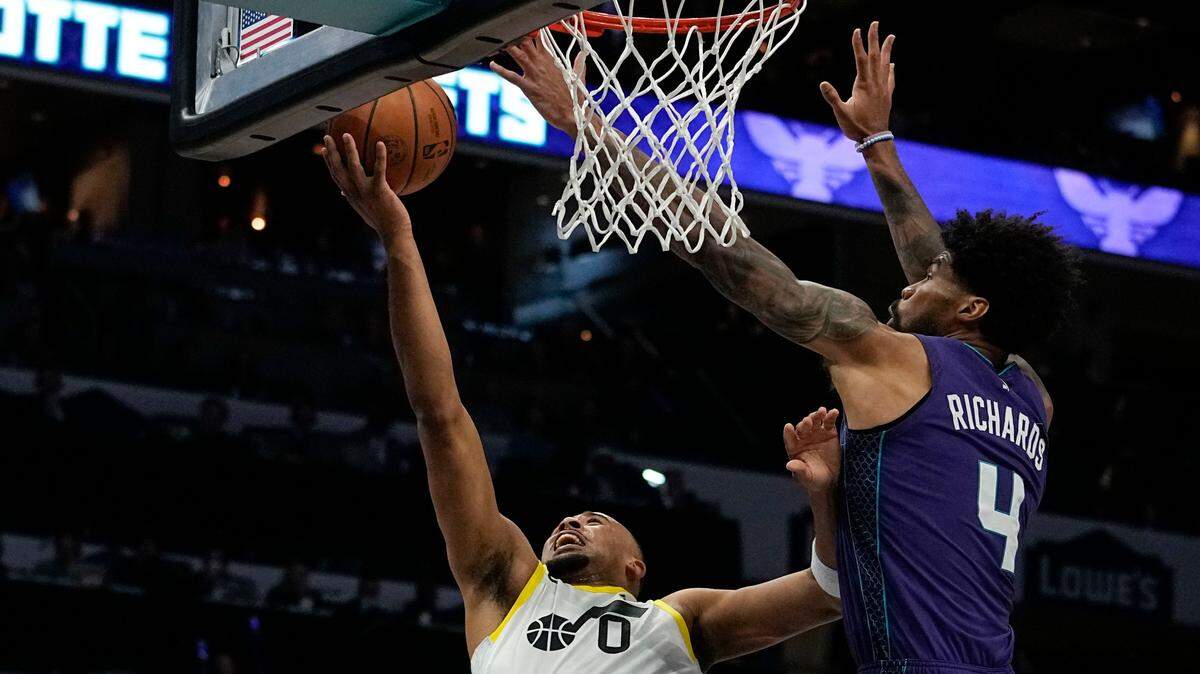 Utah Jazz guard Talen Horton-Tucker scores past Charlotte Hornets center Nick Richards during the first half of an NBA basketball game on Saturday, March 11, 2023, in Charlotte, N.C. (AP Photo/Chris Carlson)