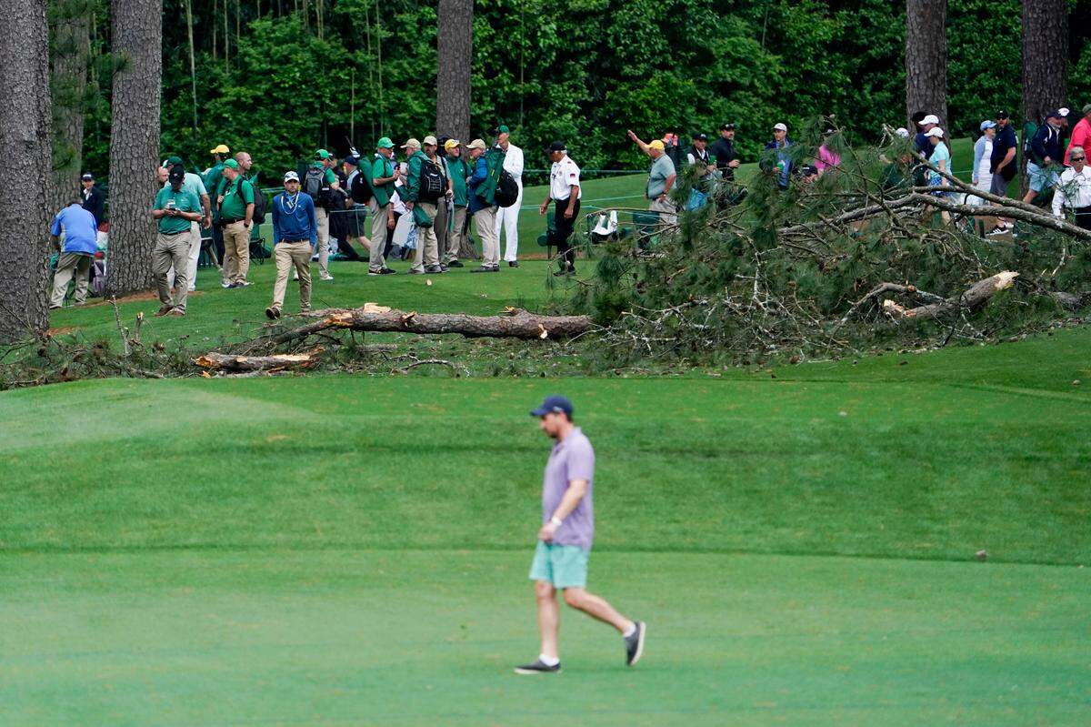 Crews work to clear downed trees near the 17th tee during the second round of The Masters golf tournament. 