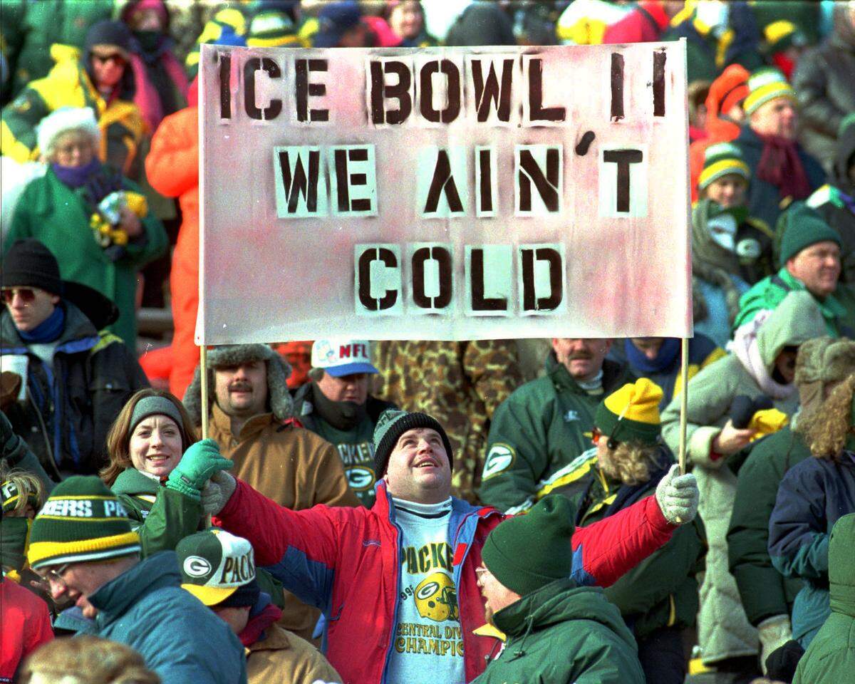 Green Bay Packers fans revel in their NFC championship win over Carolina on Jan. 13, 1997, at Lambeau Field with signs of support for their team.
