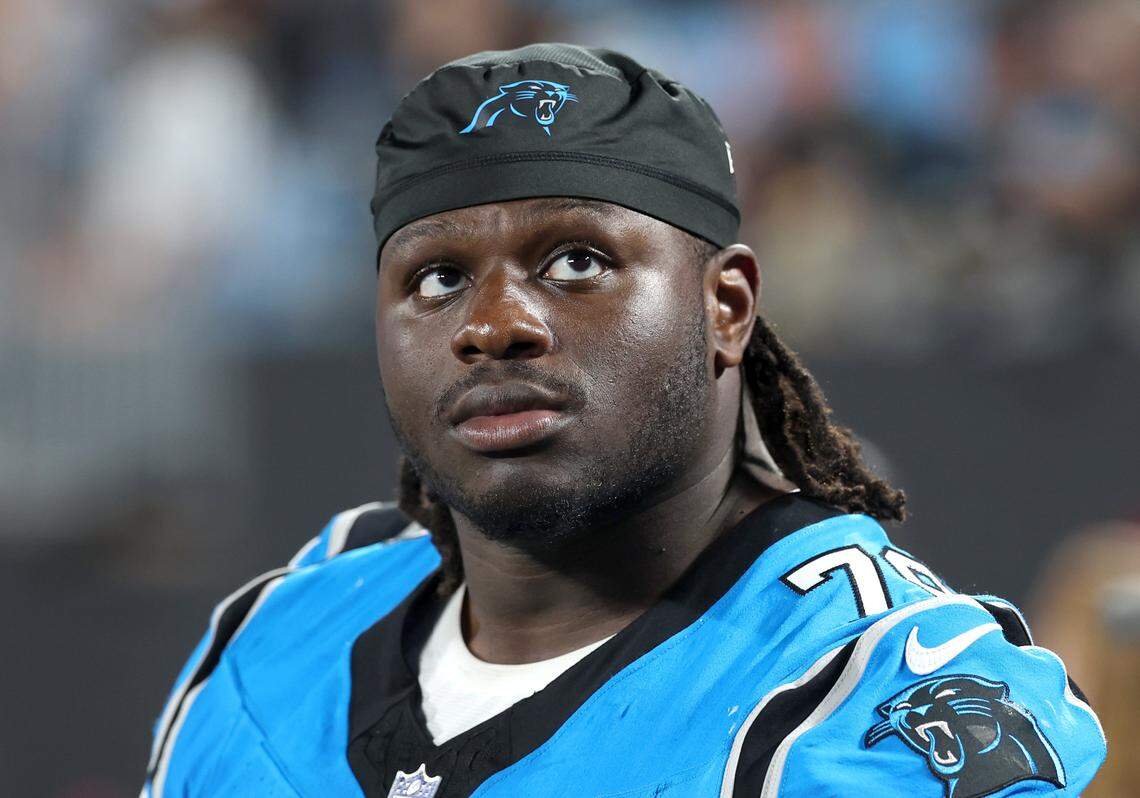Carolina Panthers tackle Ikem Ekwonu sits on the team bench during action against the Cleveland Browns on Friday, August 8, 2025 at Bank of America Stadium in Charlotte, NC. 