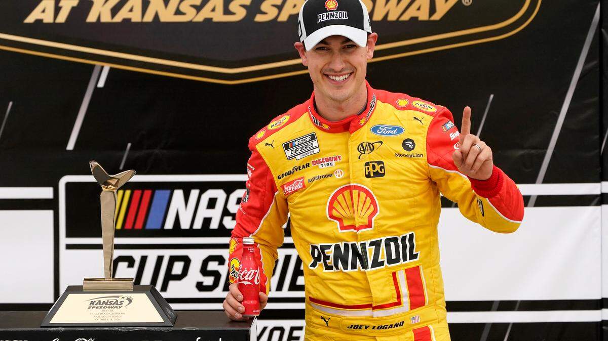 Joey Logano celebrates in victory lane after winning a NASCAR Cup Series auto race at Kansas Speedway in Kansas City, Kan., Sunday, Oct. 18, 2020. (AP Photo/Orlin Wagner)