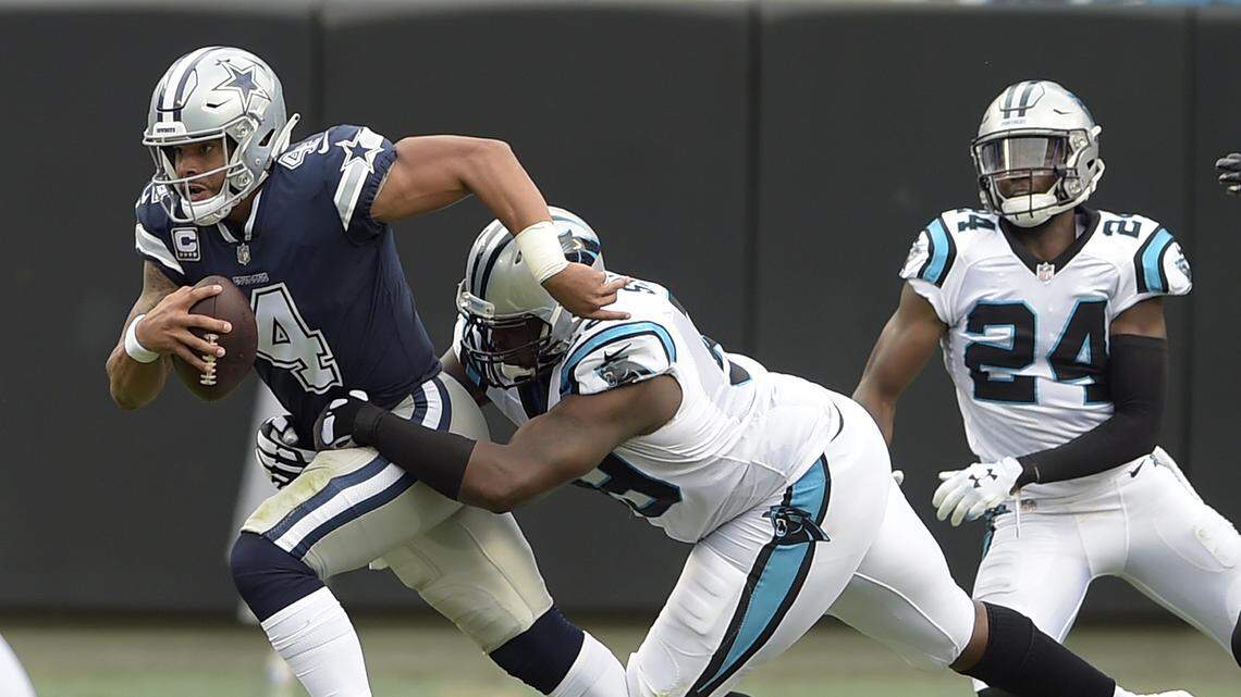 Dallas Cowboys quarterback Dak Prescott (4) is sacked by Carolina Panthers’ Kawann Short (99) during the first half Sunday.
