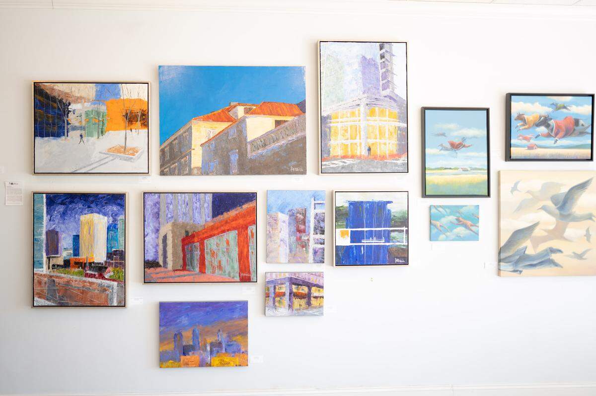 Artwork by John Komisin and Ráed Al-Rawi hangs at Carolina Fine Art, along with that of eight other Charlotte-area artists.