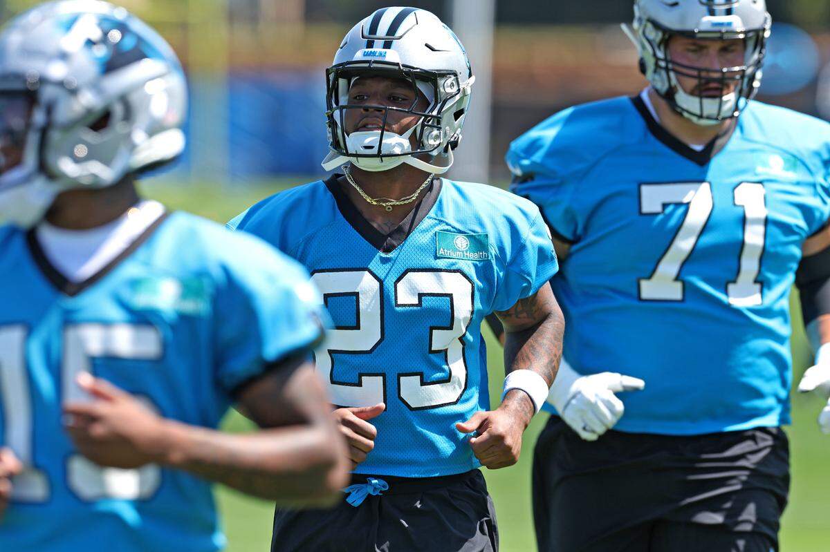 Carolina Panthers rookie running back Trevor Etienne (No. 23) and rookie offensive tackle Michael Tarquin (No. 71)  runs through drills with his teammates during the team’s rookie minicamp practice on Friday, May 9, 2025. 
