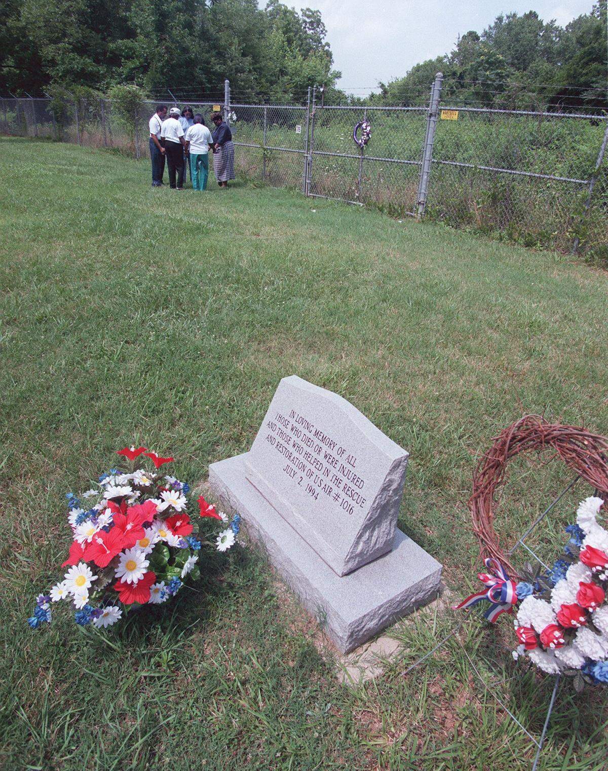 Family and friends of Renee Bates gather to pray at the site of the 1994 crash of USAir Flight 1016 in Charlotte. The crash, one of 328 fatal plane crashes in N.C. since 1983, killed 37 people.