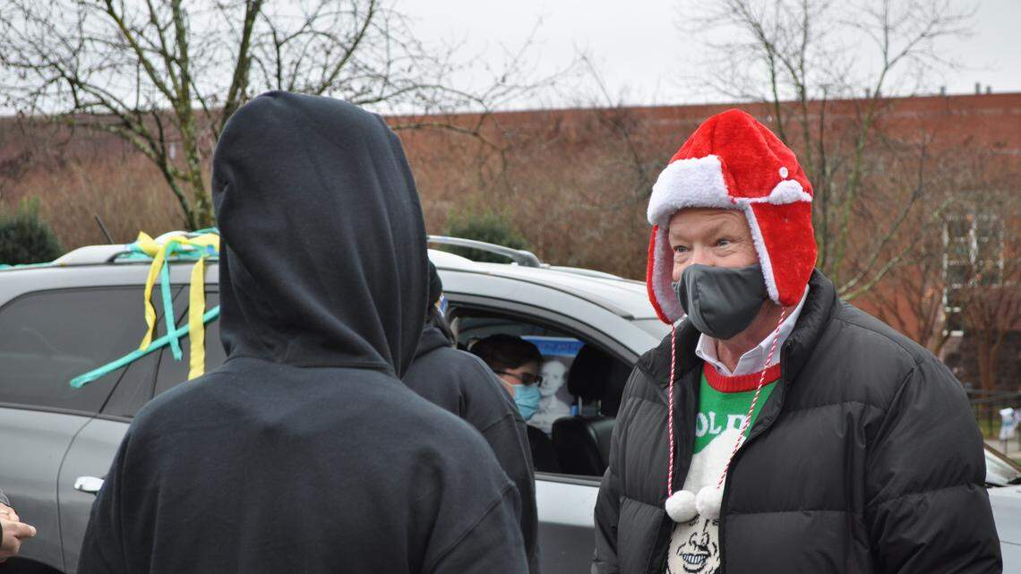 Family members, students and teachers organized a drive-thru retirement parade for Joey Burch, principal at Levine Middle College High School. 