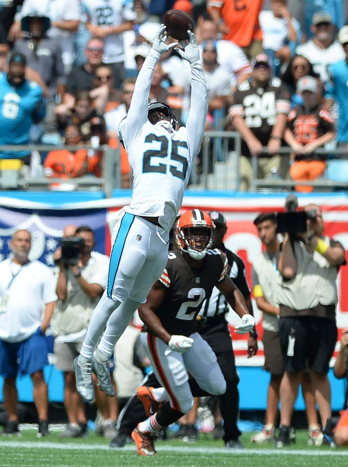 Carolina Panthers safety Xavier Woods leaps to disrupt a pass to Cleveland Browns wide receiver Amari Cooper during first quarter action at Bank of America Stadium on Sunday, September 11, 2022.