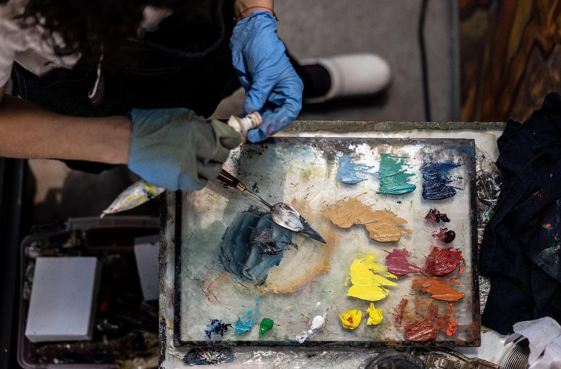 Samantha Rosado works mostly with oil paints in bright colors, which she layers onto canvases to mimic her home and family’s images.