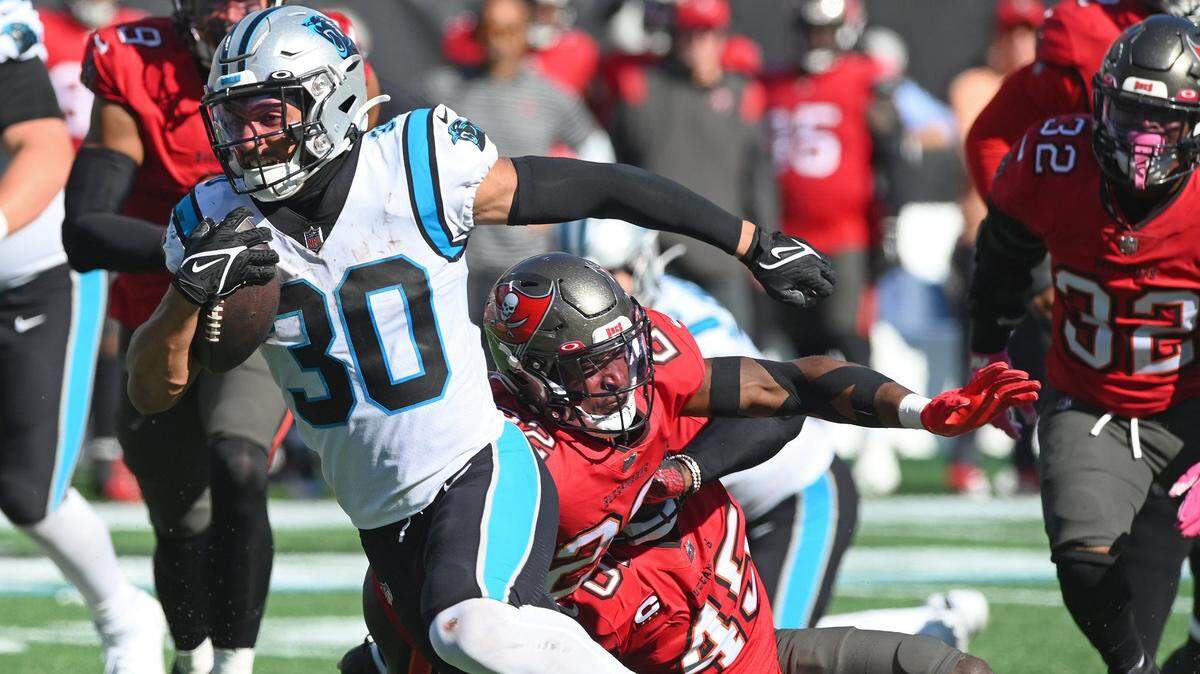 Carolina Panthers running back Chuba Hubbard, left, breaks free of the Tampa Bay Buccaneers defense on a touchdown run during second half action at Bank of America Stadium in Charlotte, NC on Sunday, October 23, 2022. The Panthers defeated the Buccaneers 21-3.