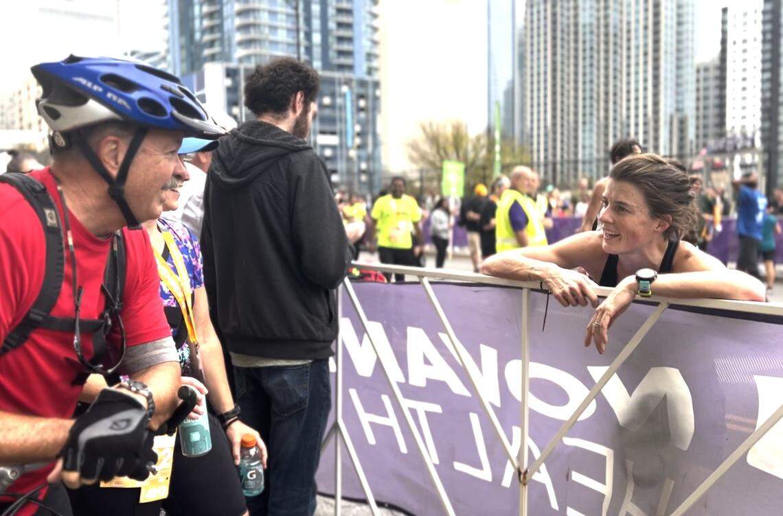 Erin Del Giudice talks to her father, Chris Osment, after she crossed the Charlotte Marathon finish line as the women’s winner.