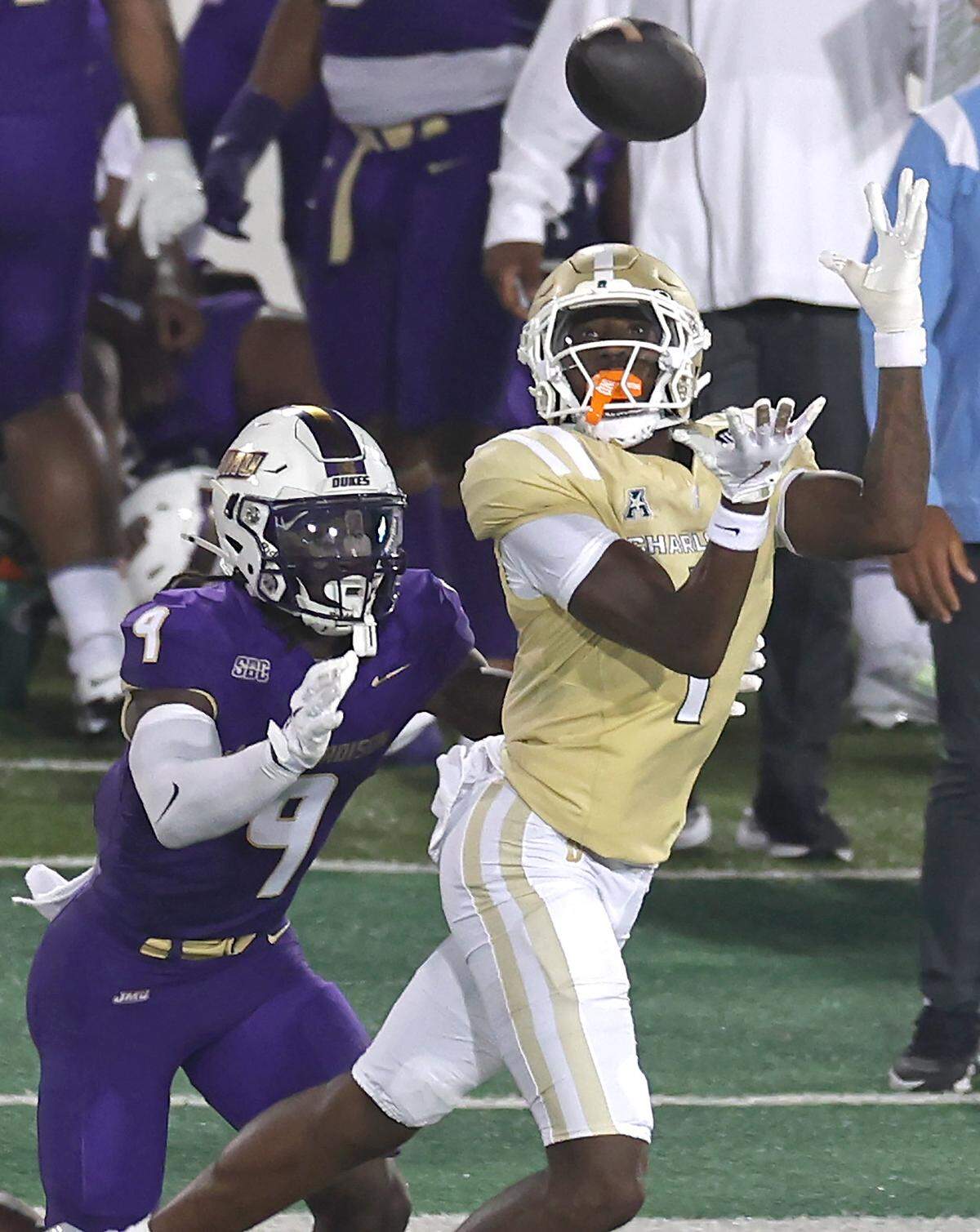 Charlotte 49ers defensive back Dontae Balfour, right, intercepts a pass by James Madison University quarterback Alonza Barnett III as JMU wide receiver Omarion Dollison, left, looks on during action on Saturday, August 31, 2024 at Jerry Richardson Stadium.