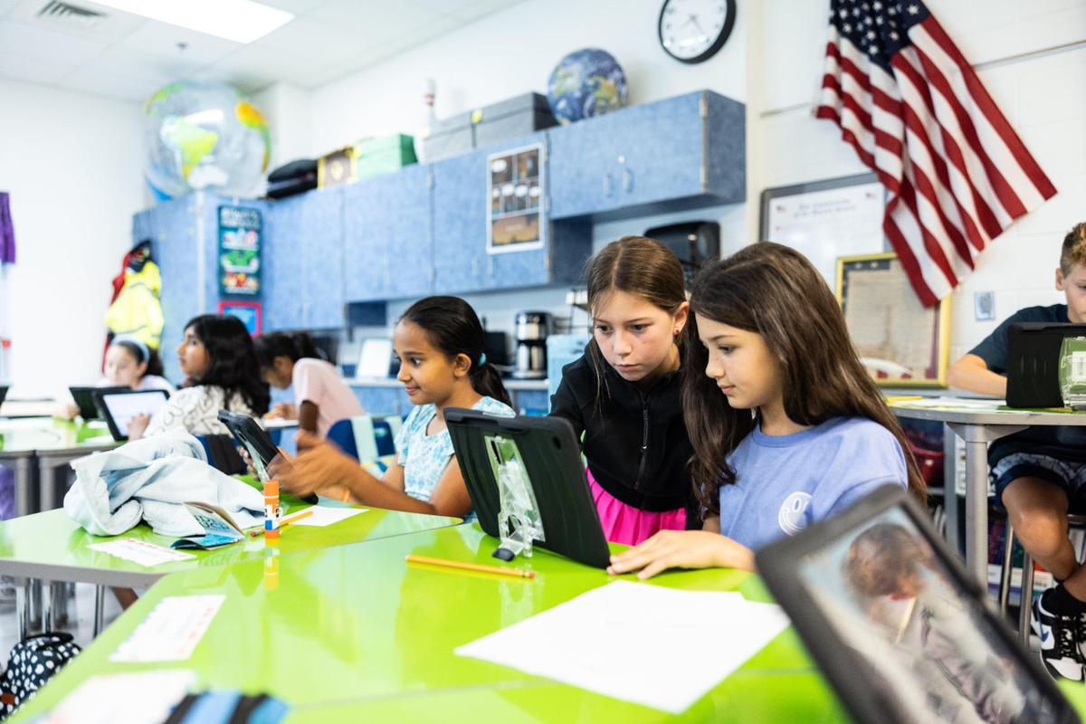 A 5th grade class sets up their iPads during the first day of school at Lake Norman Charter Middle School in Huntersville, N.C., on Thursday, August 10, 2023.