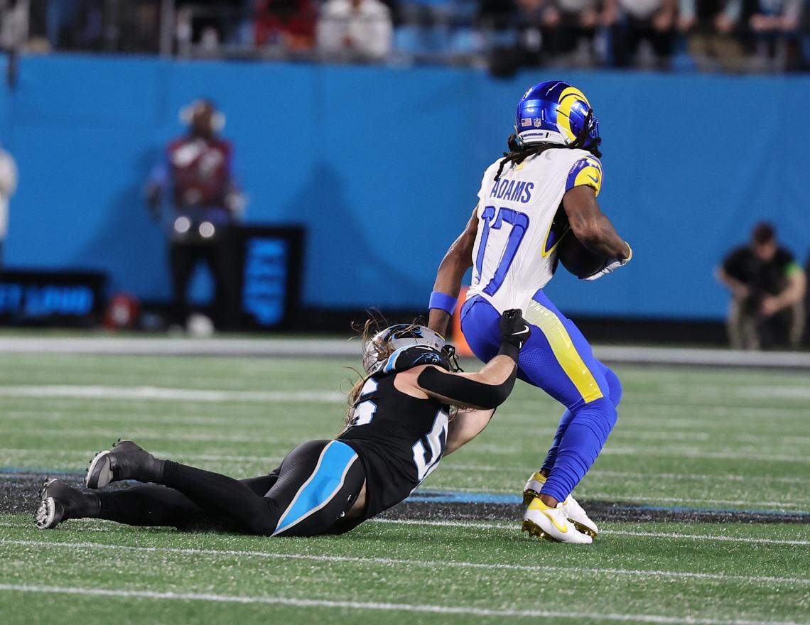 Carolina Panthers linebacker Christian Rozeboom tries to bring down Los Angeles Rams wide receiver Davante Adams the wild card playoff game against the Rams at Bank of America Stadium on Saturday, Jan. 10, 2025 in Charlotte