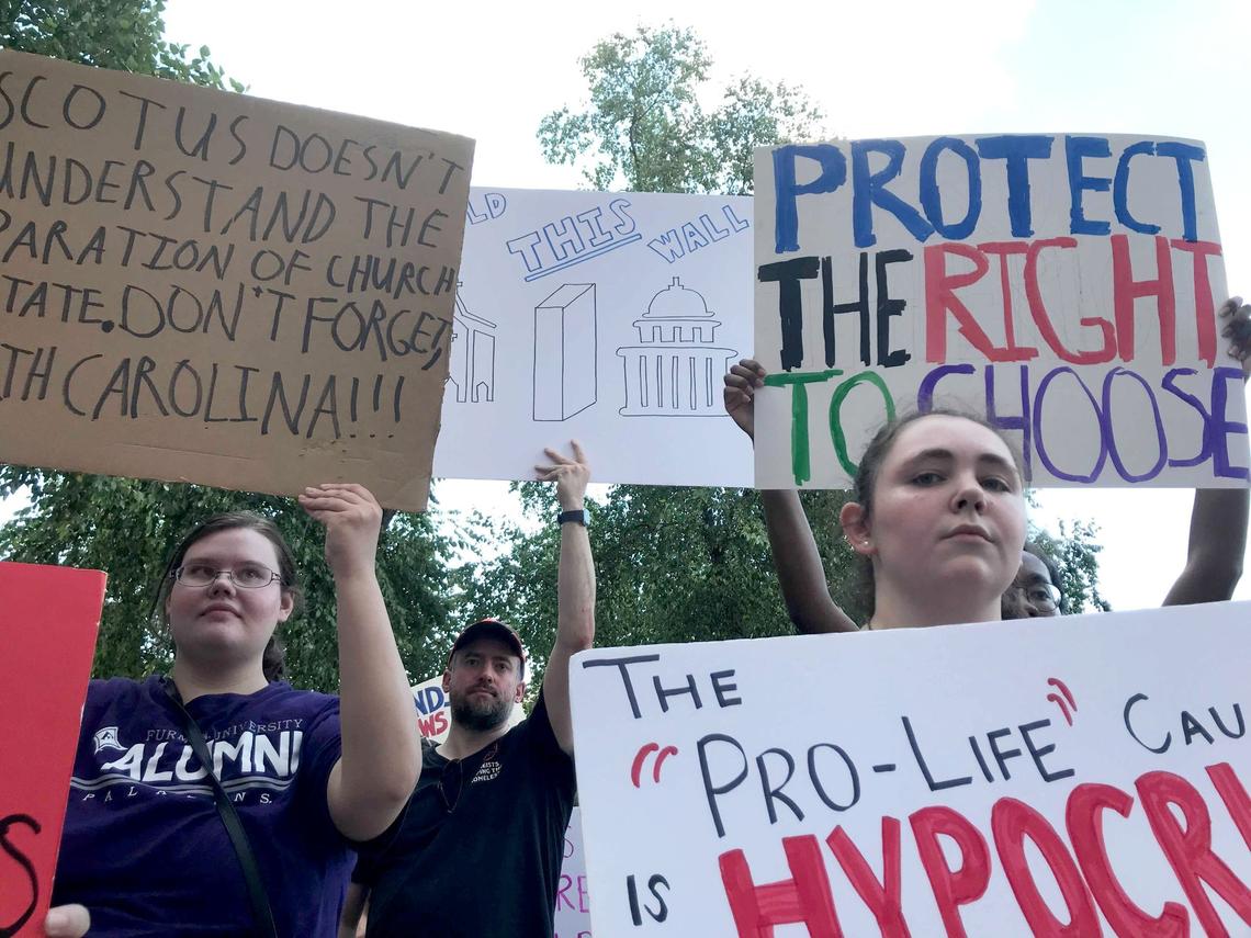 Demonstrators gathered outside the Charlotte-Mecklenburg Government Center in uptown on Friday evening to protest the U.S. Supreme Court’s decision to overturn Roe v. Wade, ending the constitutional right to an abortion.
