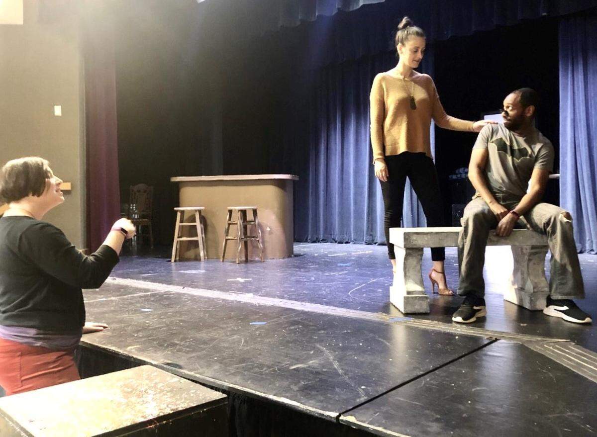 Sarah Provencal, director of “The Sabbath Girl,” works with actors Karina Caporino (Angie) and Devin Clark (Blake) on stage at JSTAGE at the Levine Jewish Community Center. The play is a romantic comedy about an unlikely relationship between an Orthodox Jewish knish shop owner (Steve Kaliski) and a non-Jewish woman.